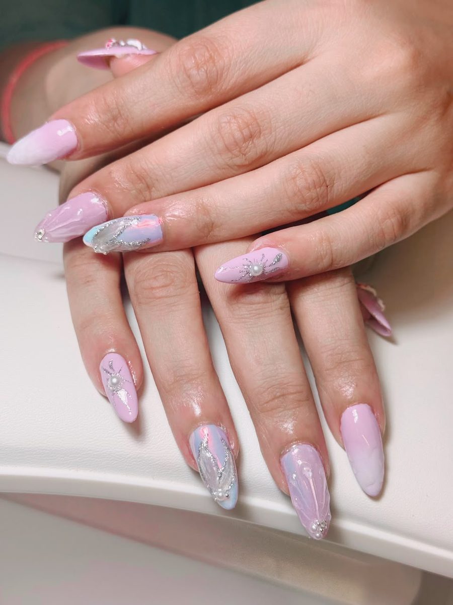 Pink pearl almond nails with silver hand-painted detail by Kim's Studio Lahore