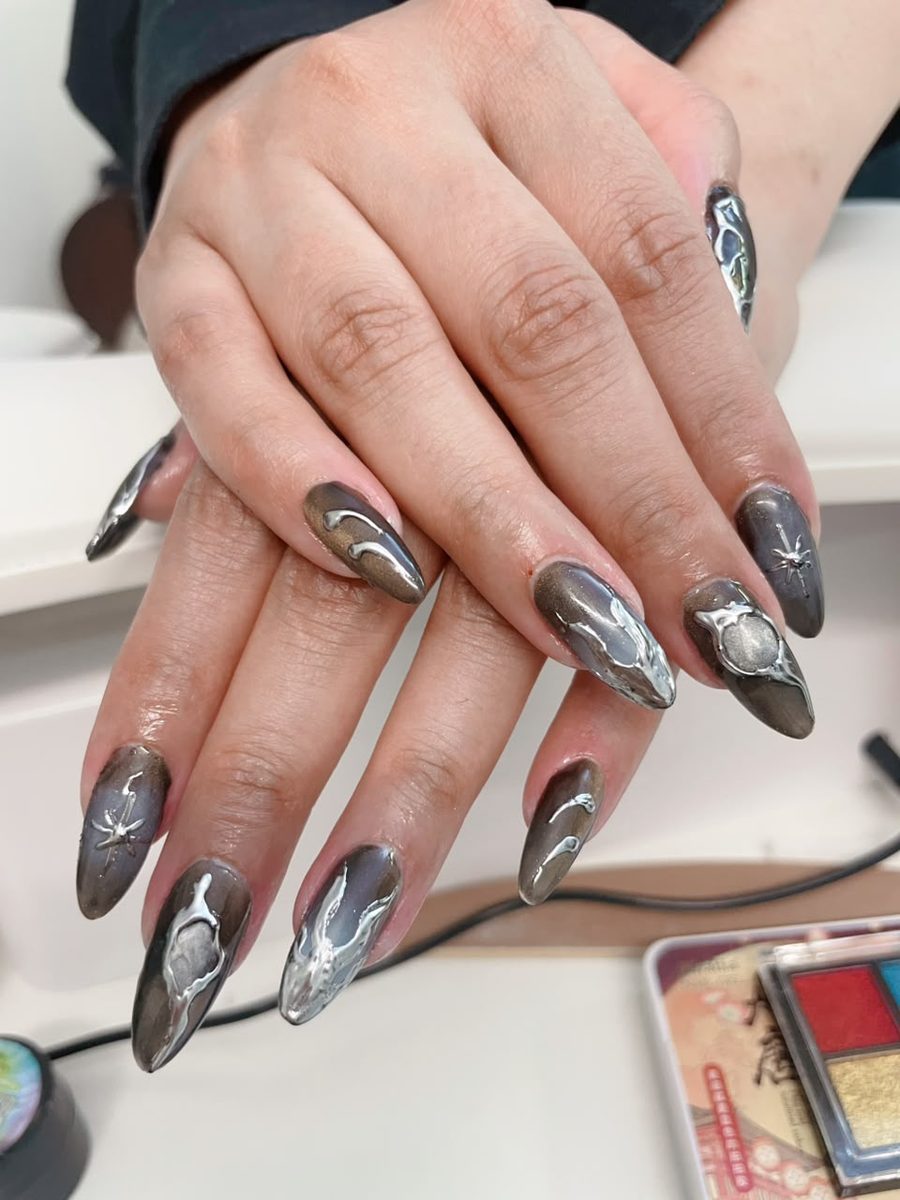3D chrome metallic nail art on almond nails by Kim's Studio Lahore